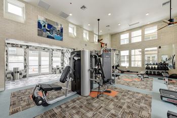 Fitness Center with Excercise Bikes, Ellipticals, Ceiling Fan and Patterned Rug